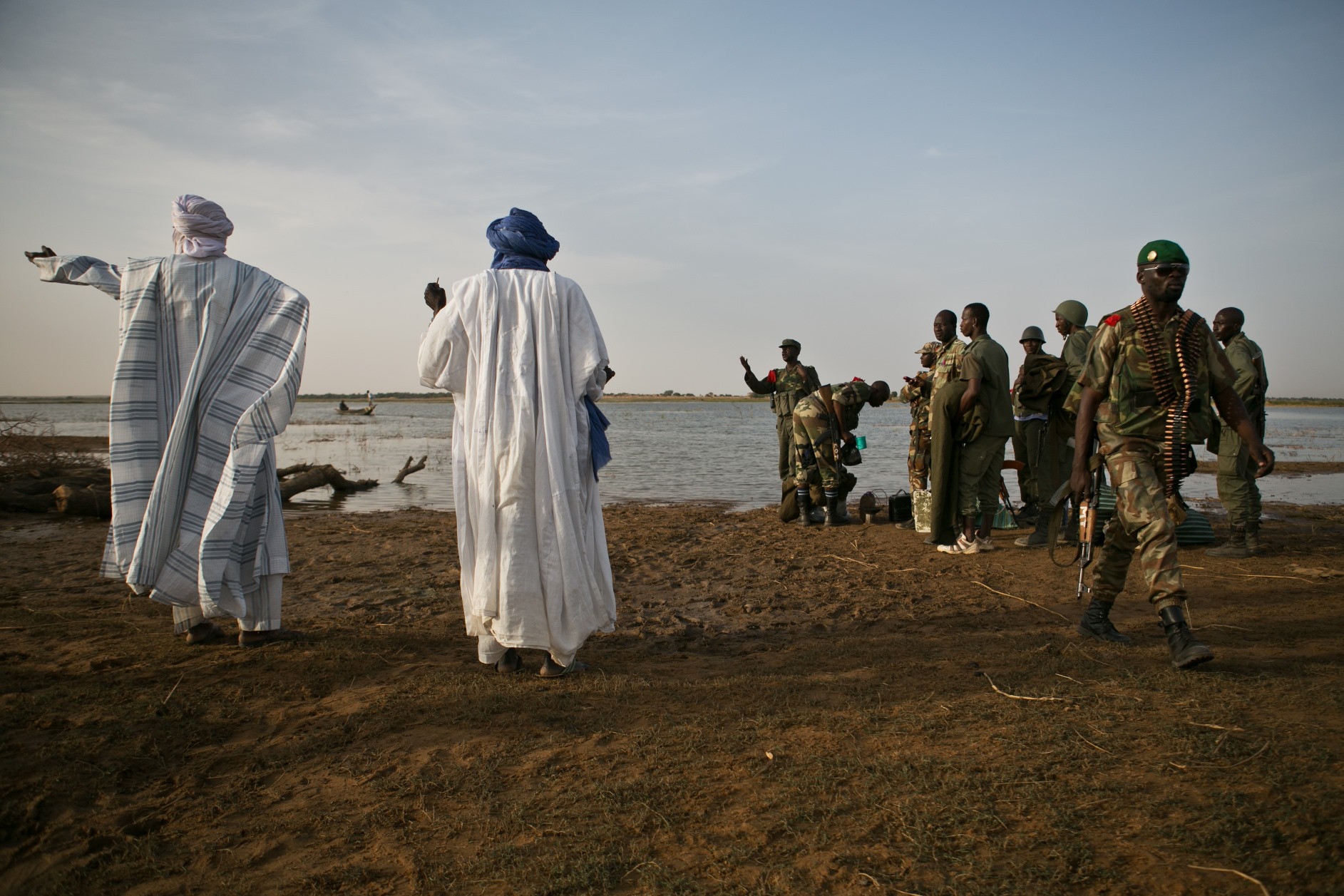 A Malian man points to Kadji, a town surrounding Gao where it is thought that members of MUJAO have been in hiding, in Kadji, Mali, 1 March 2013.