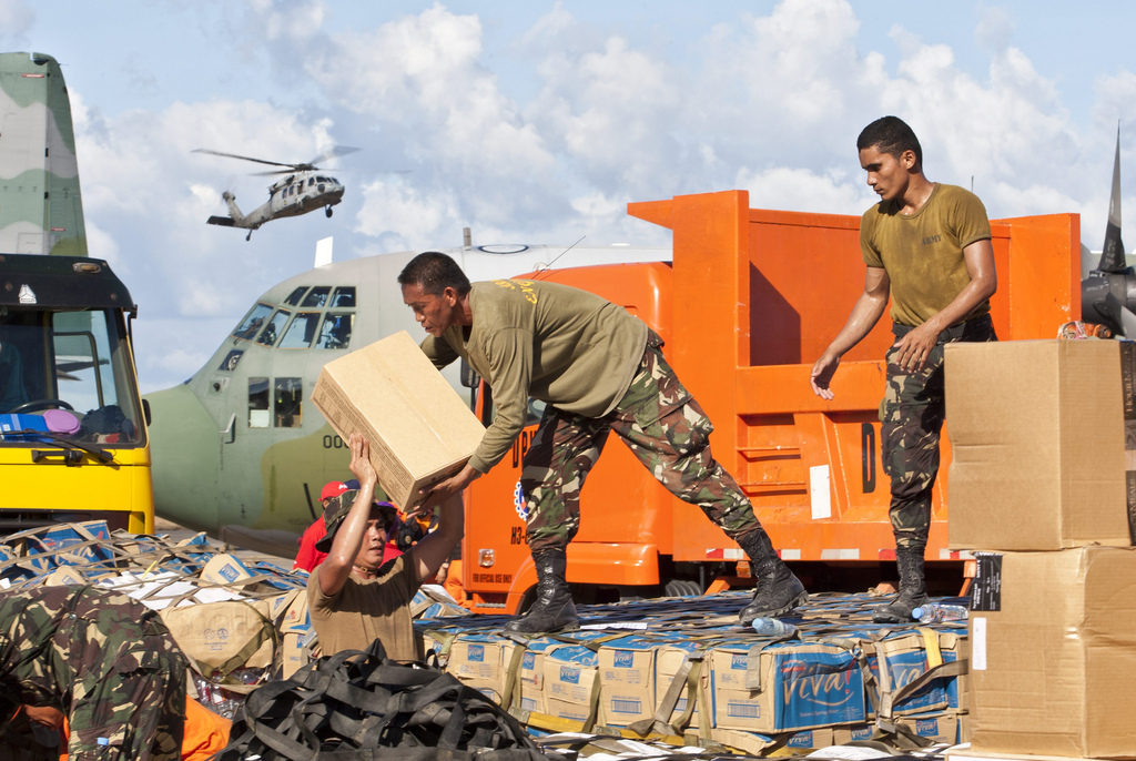 Members of the Philippine military load relief goods at Tacloban's airport