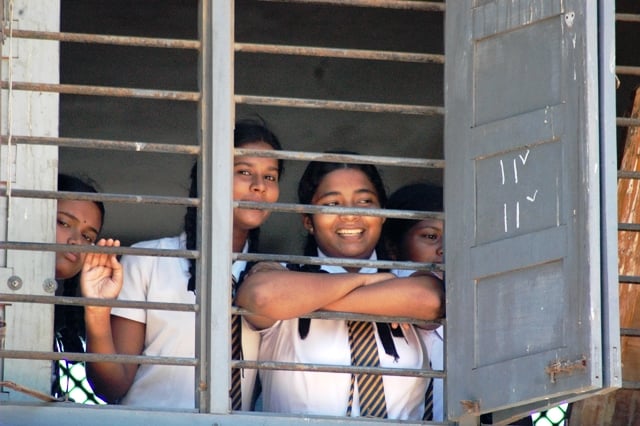 A group of school girls look to the camera in Colombo