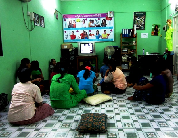 Commercial sex workers watch TV at a PSI drop-in centre in Yangon
