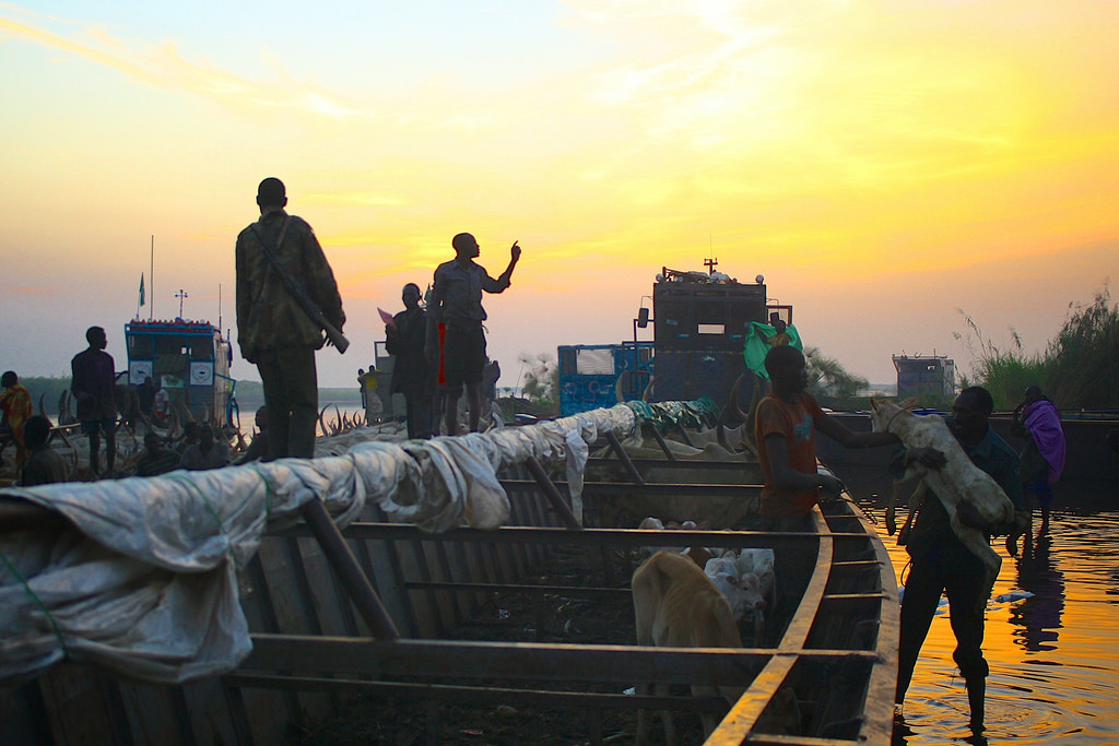 People arrive at dawn to Awerial settlement fleeing the conflict in and around the town Bor. Those who make the treacherous journey are being charged extortionate fees to cross the river Nile to safety, often spiralling into debt to afford the fare. An es