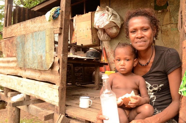 A mother and her child outside their home at the 9 Mile settlement outside Port Moresby. Thousands of people in such settlements are without proper access to toilets. More than half the country's 7.5 million population practice open defecation