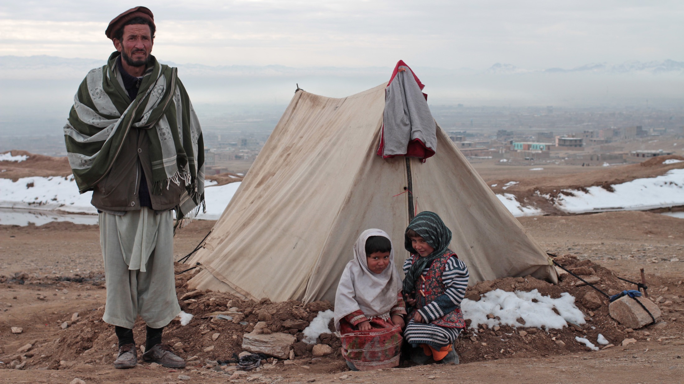 Displaced families from Ghor province in Afghanistan shelter outside Herat in freezing temperatures