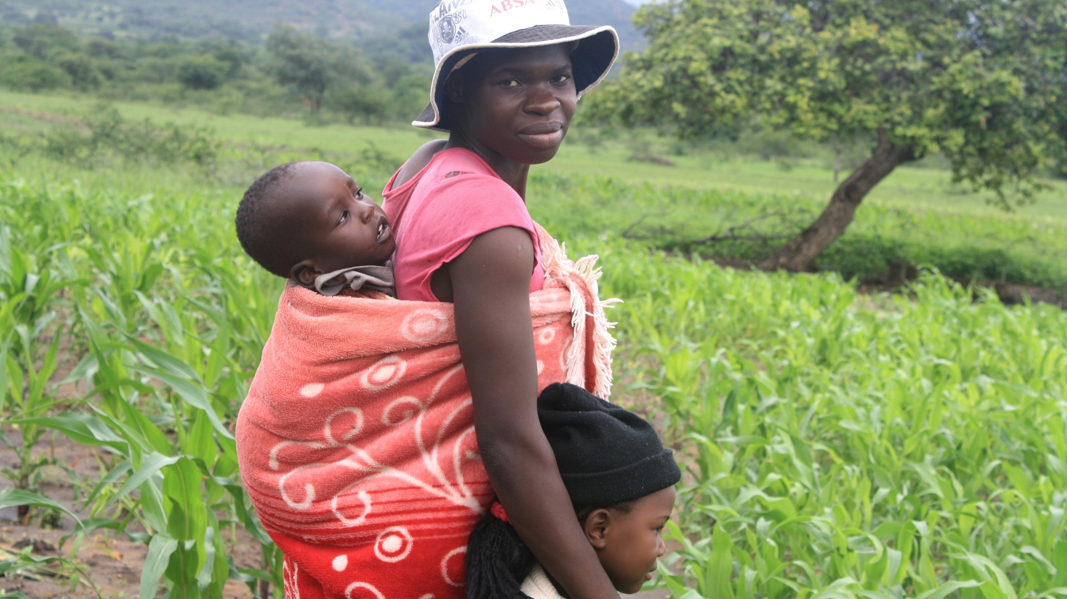 Eugenia Musakanda, with her two children at her field in the Sipamphi area in Zimbabwe’s Masvingo province