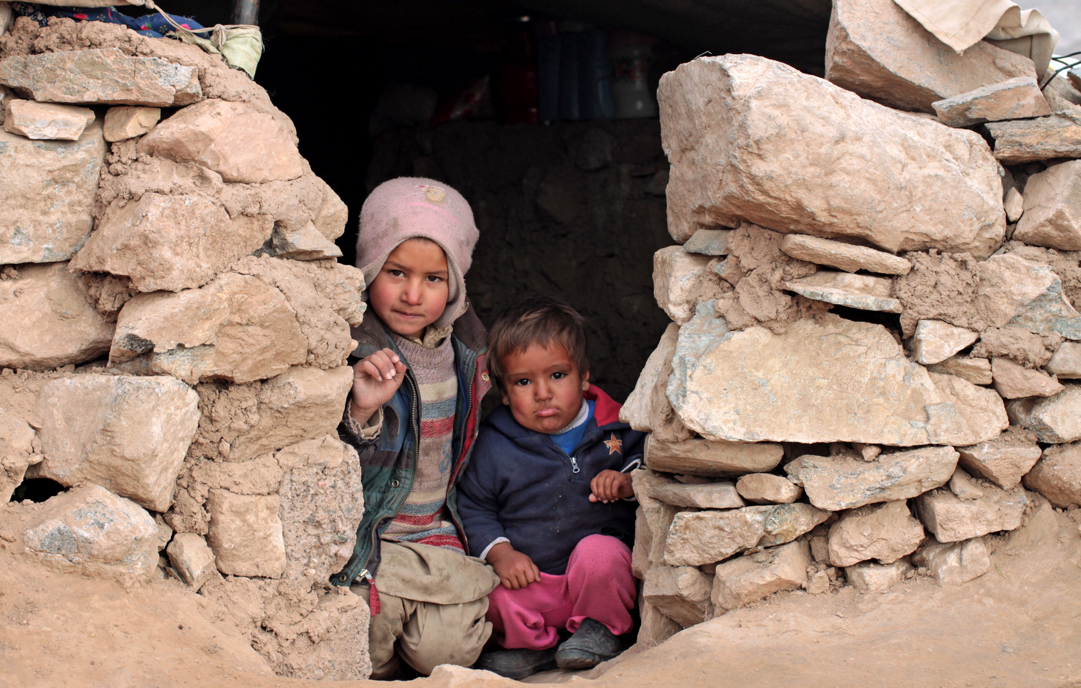 Displaced families from Ghor and Badghis provinces share temporary shelters on the outskirts of Herat