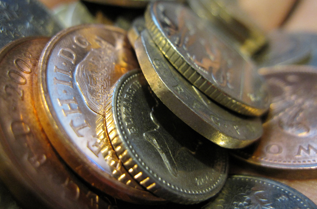 A handful of money, UK sterling coins.