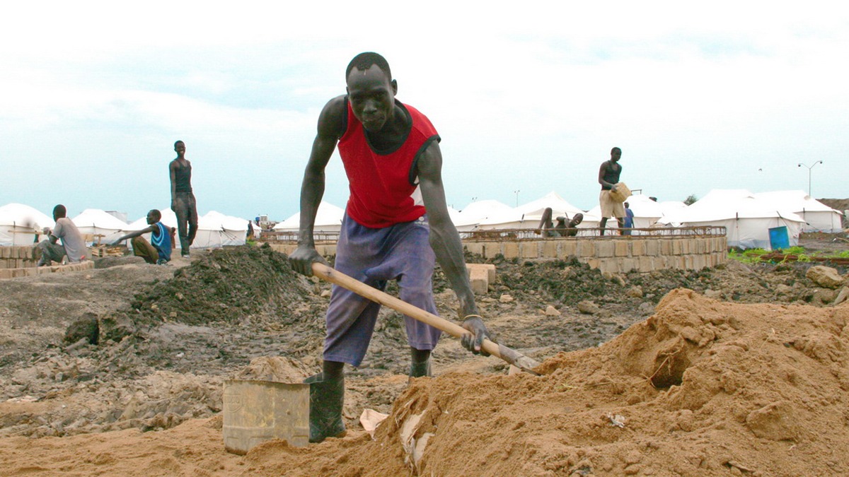 A man shovels sand for a waste-water treatment facility within the new IDP camp at the UN base in Malakal, South Sudan