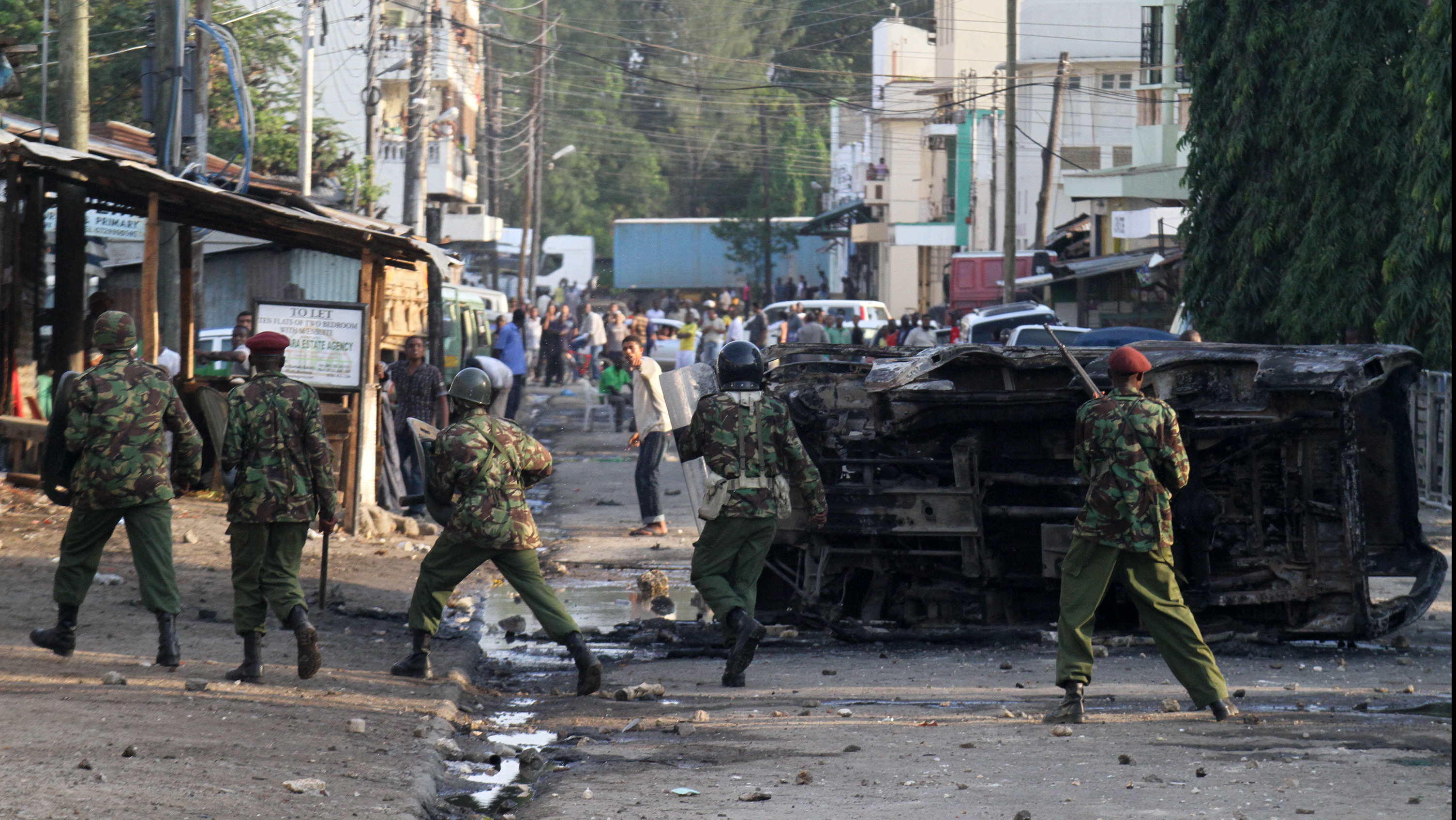 Kenyan security personnel engaging in a street fight with rowdy youths outside the Masjid Musa Mosque in Majengo, Mombasa