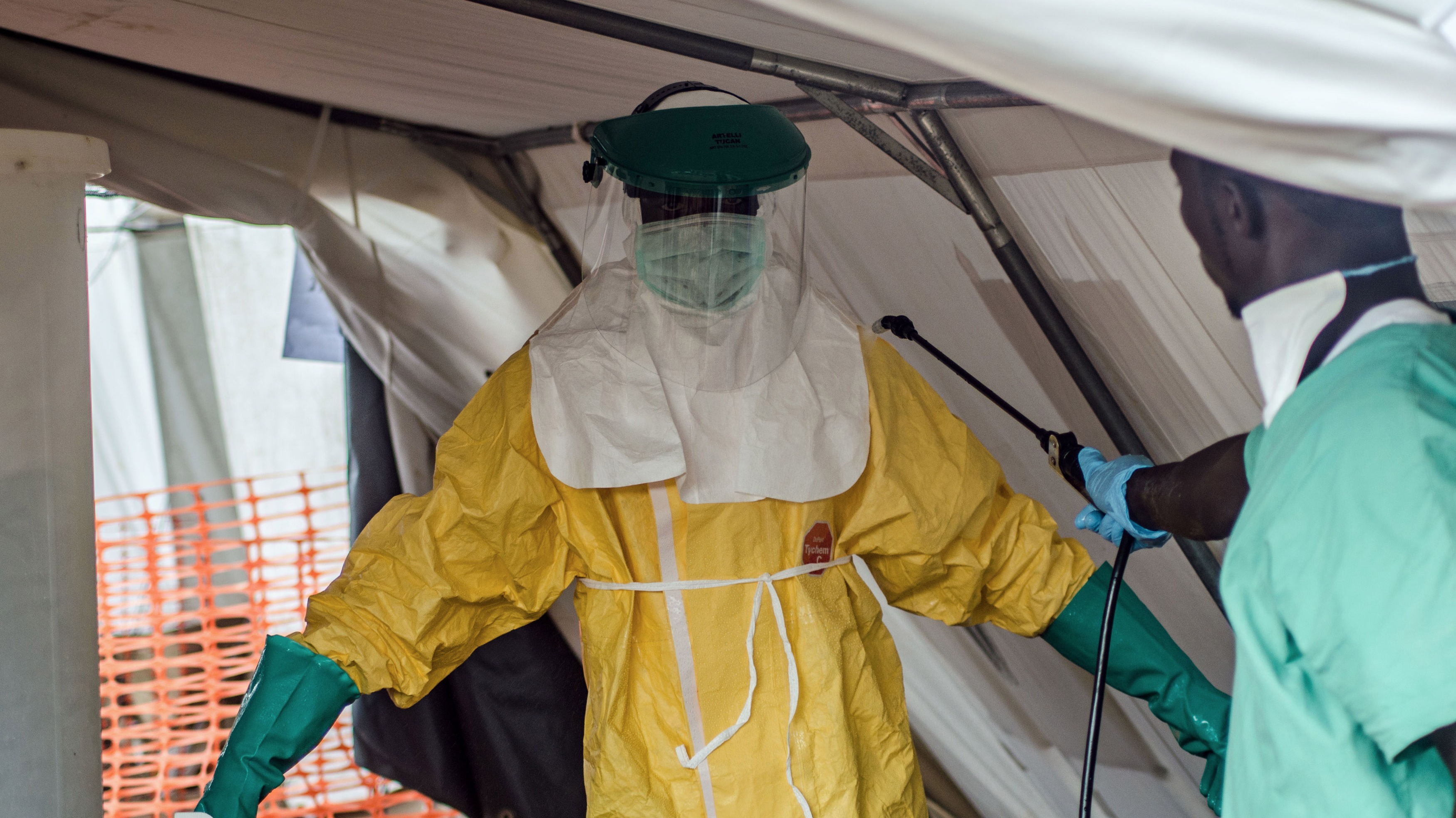 An MSF health worker donning a protective suit to treat Ebola victims in Kailahun, Sierra Leone. July 2014.