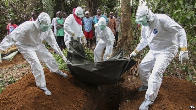 A team trained to bury the bodies of Ebola victims at work in Liberia