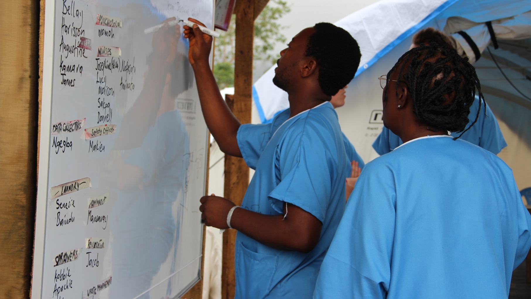 Health workers outline the day's activities at the IFRC Ebola treatment centre outside of Kenema, Sierra Leone. (Oct 2014)