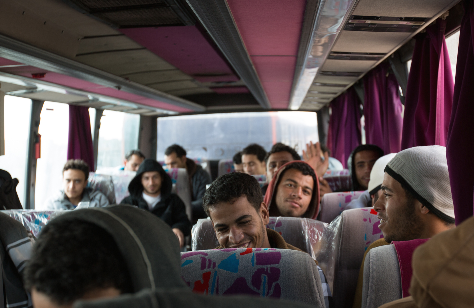 Egyptian workers held in a detention centre for illegal immigrants near Misrata on board a bus to Tunisia, from where they will be flown home.