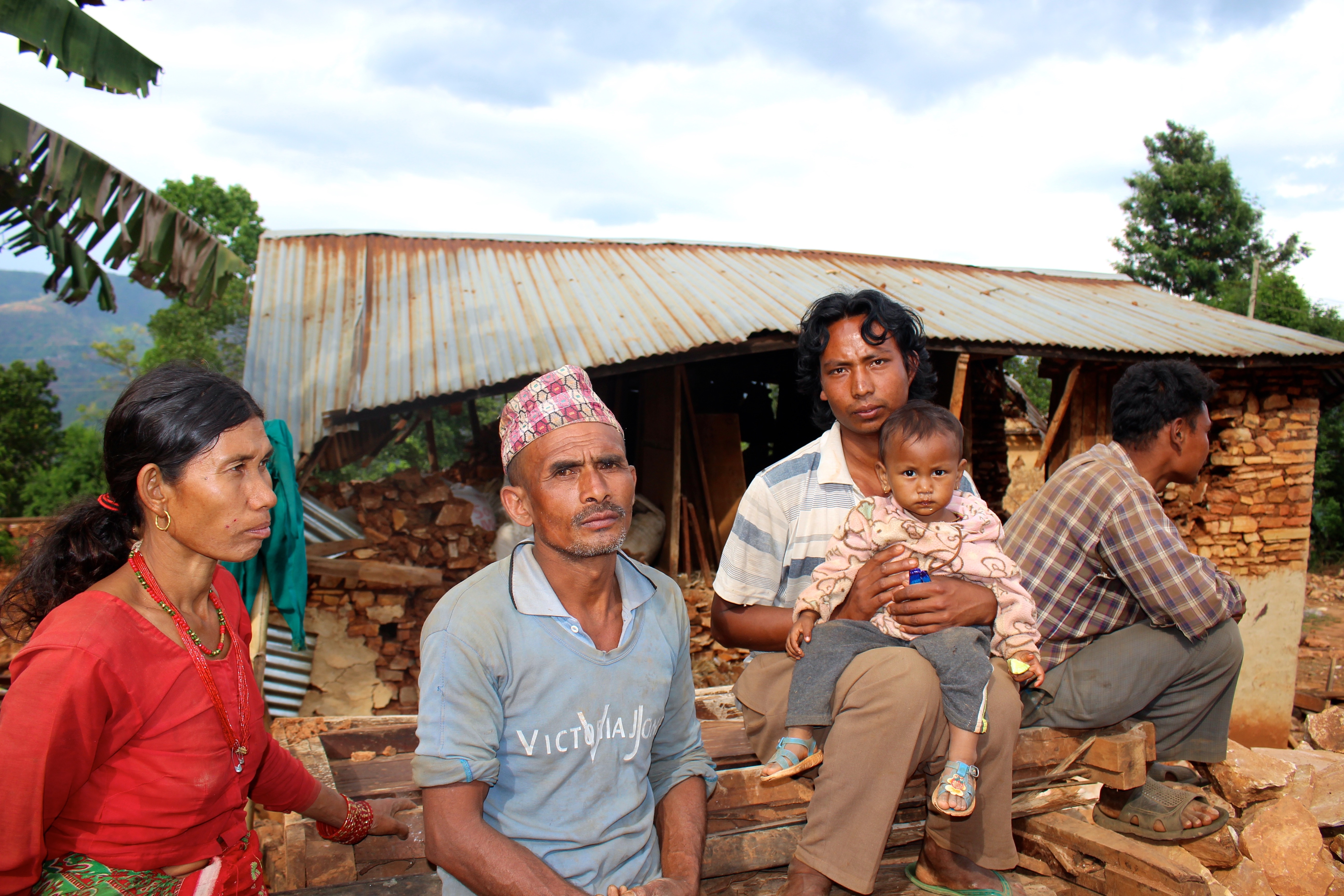 Bir Bahadur Rai and his family in front of their two houses that were completely destroyed in Banghar village after a major earthquake struck Nepal on 25 April 2015.