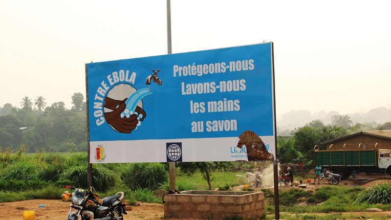 A billboard reading: Against Ebola - Let's protect ourselves. Hand-wash with soap