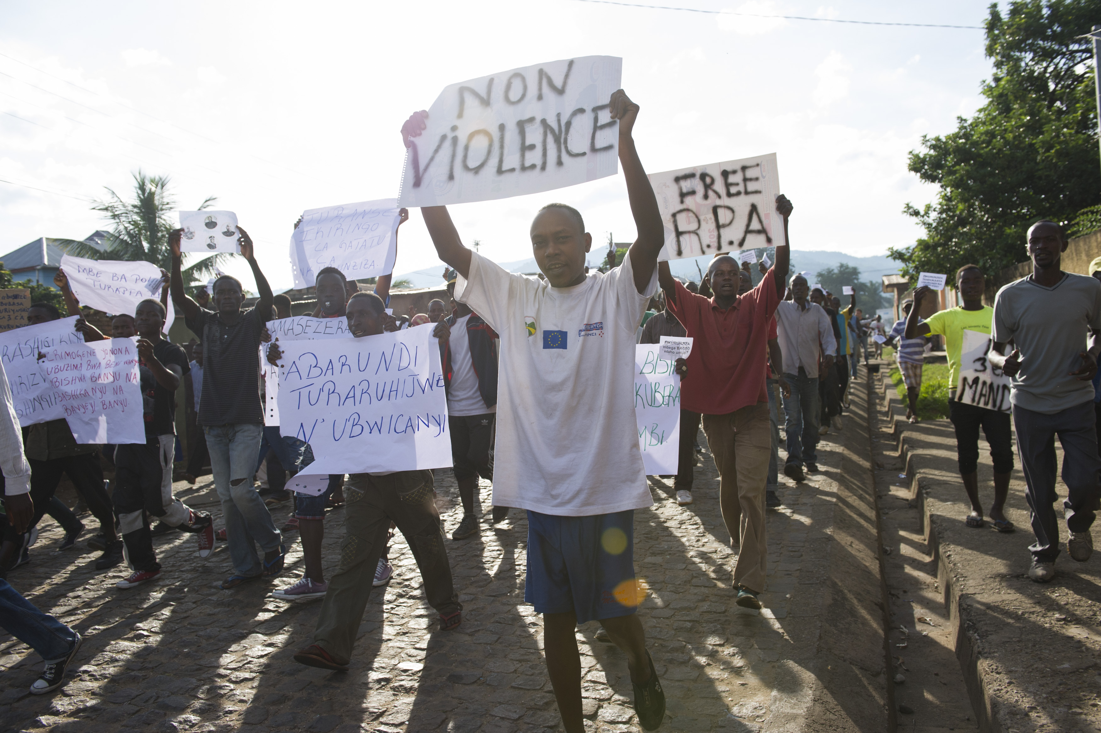 Protestors demonstrate carrying placards announcing