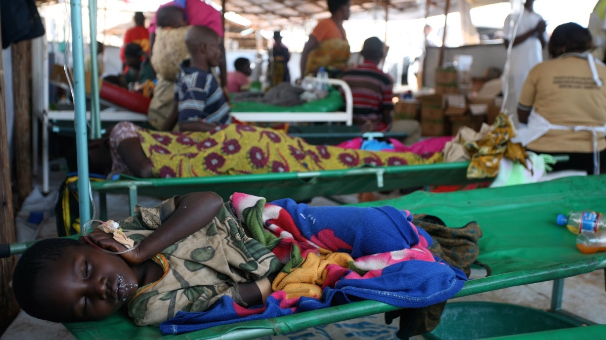 A young Burundian refugee suffering from diarrhoea with suspected cholera lies in the health clinic at Lake Tanganyika Stadium in Kigoma, Tanzania. Tens of thousands of Burundians have fled across borders to neighbouring countries amid growing political t