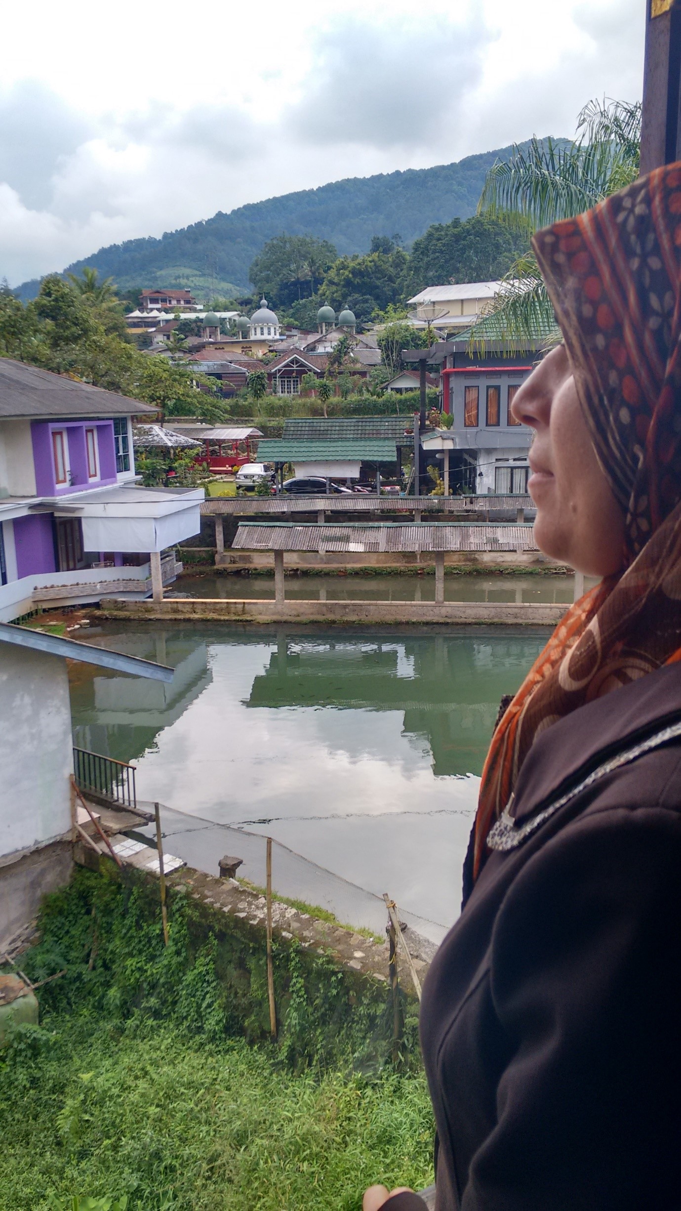 Maysoon looks out over Ciasura in Indonesia where she and her family have spent the last nine months waiting for UNHCR to process their asylum applications