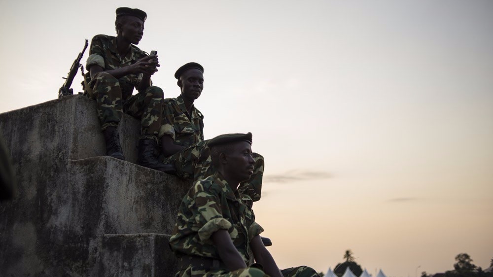 Soldiers from the Burundian armed forces sit next to a makeshift polling station in the Musaga neighbourhood of Bujumbura, Burundi, on June 28, 2015.Burundians are set to vote in legislative elections tomorrow, which opposition parties have called to boyc