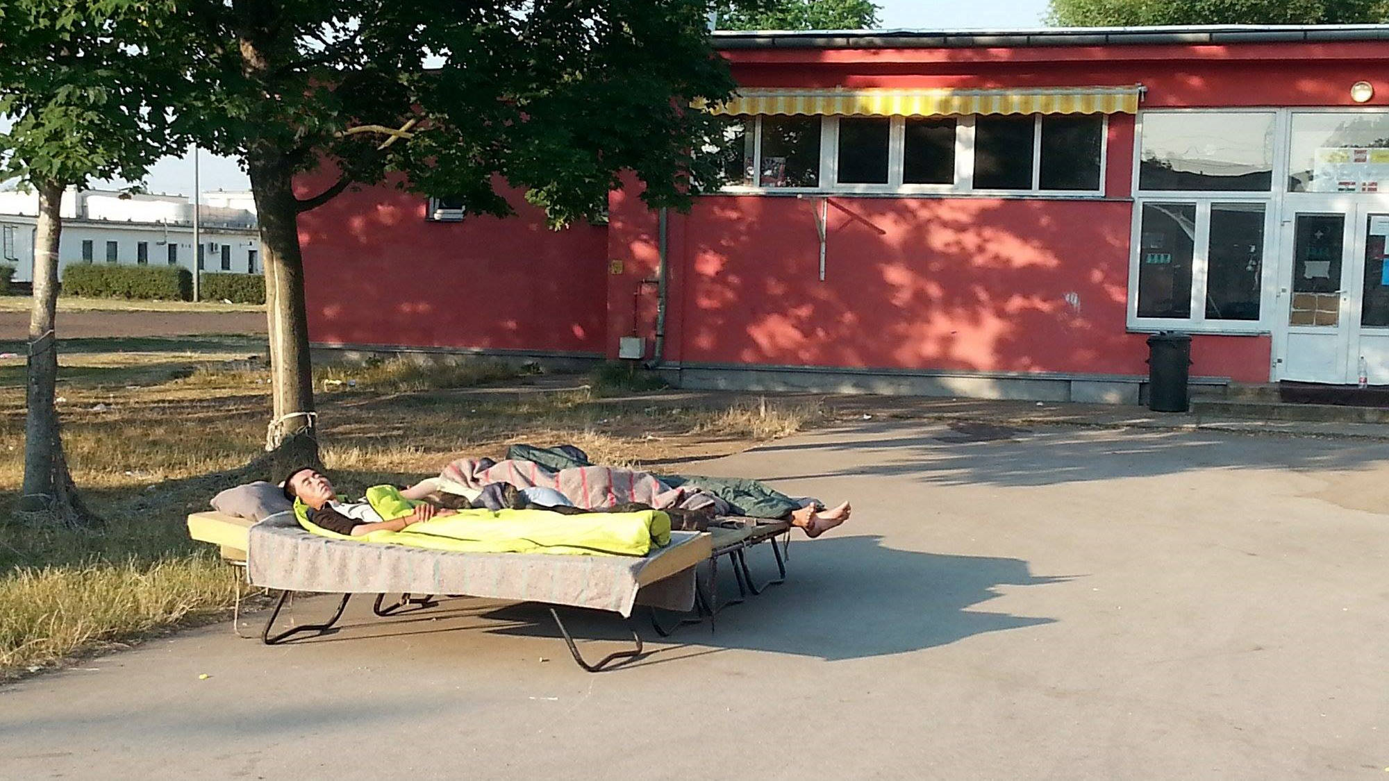 New arrivals at the Debrecen centre for asylum seekers in Hungary have to sleep outside because of overcrowding. The centre has an official capacity of 1,000 but currently has about 2,000 people staying there.
