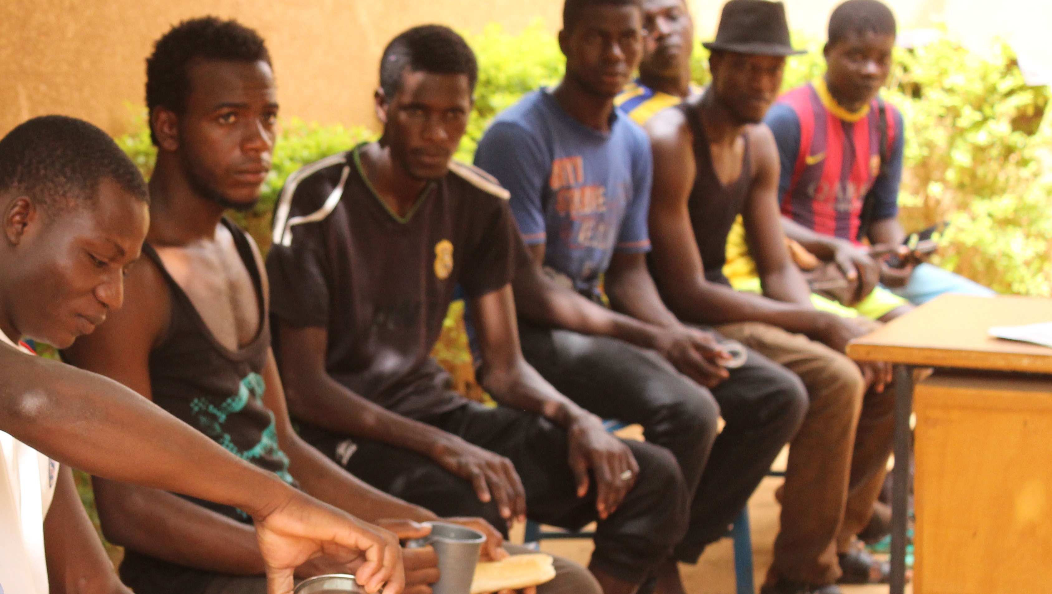 A group of West African would-be migrants, who failed to complete their journey to Europe, await repatriation outside the International Organisation for Migrants' reception centre in Niamey, Niger.