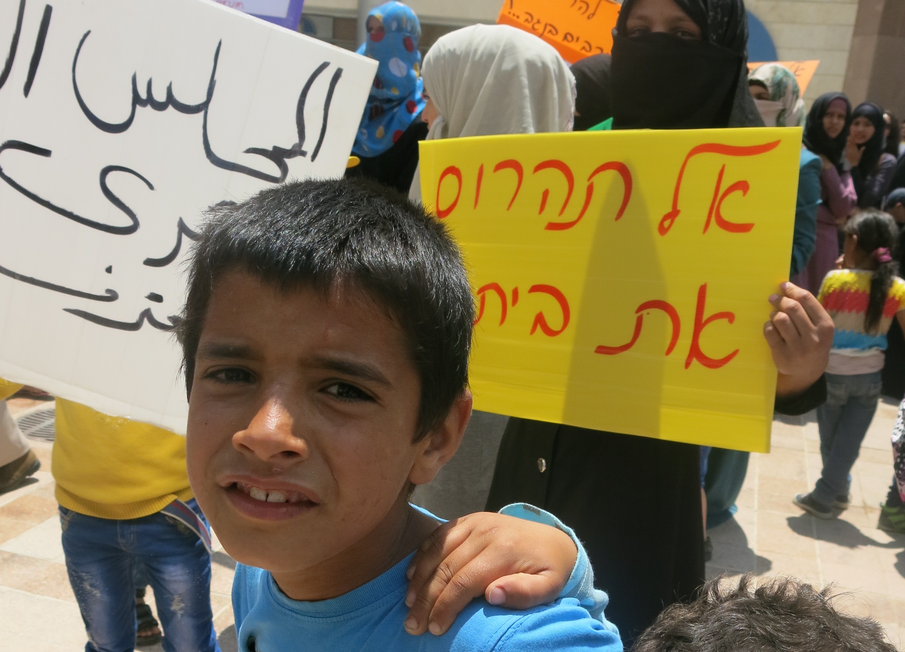 A young Palestinian protests the destruction of his town in the West Bank