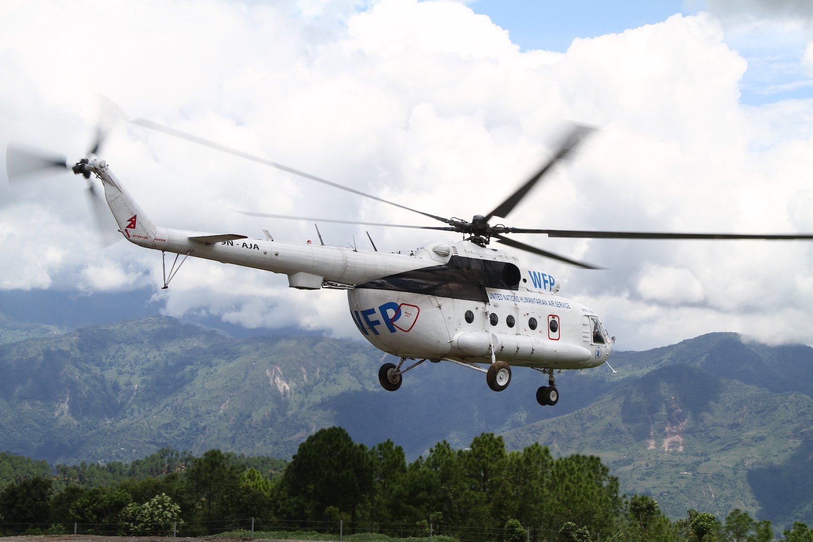 A United Nations helicopter takes off from Chautara, in Nepal's Sindhupalchok District, to transport roofing material to a remote village to rebuild homes damaged in the earthquakes of April and May 2015.