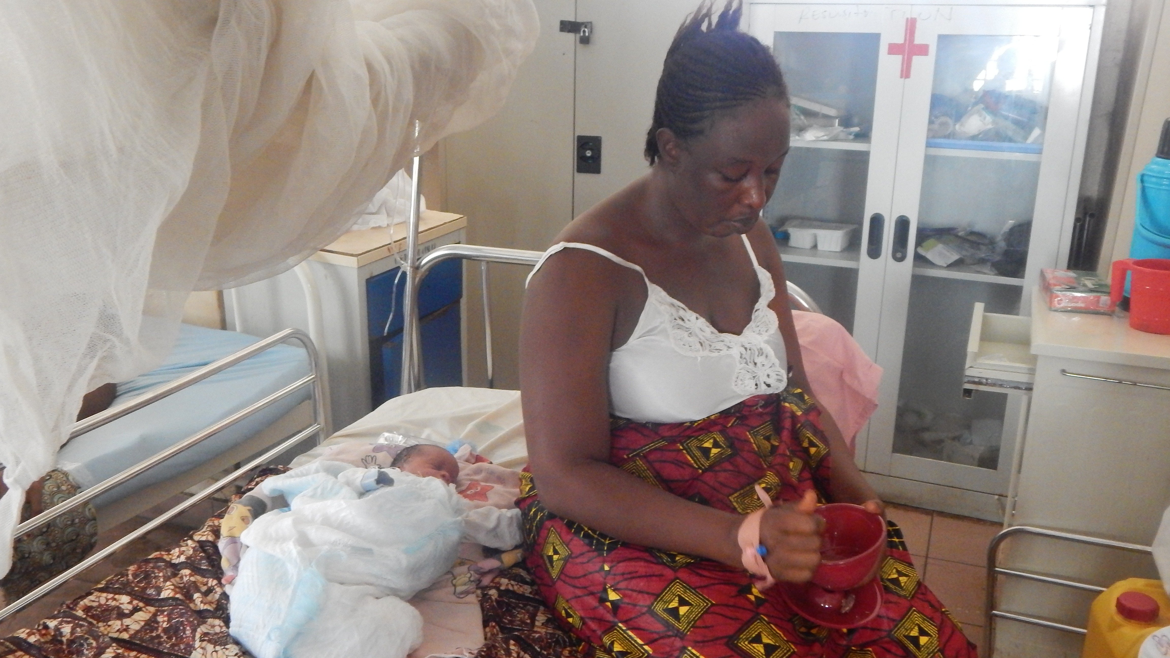 Aisha Kargbo sits besides her newborn child at the PCMH (Cottage) Hospital in Freetown.