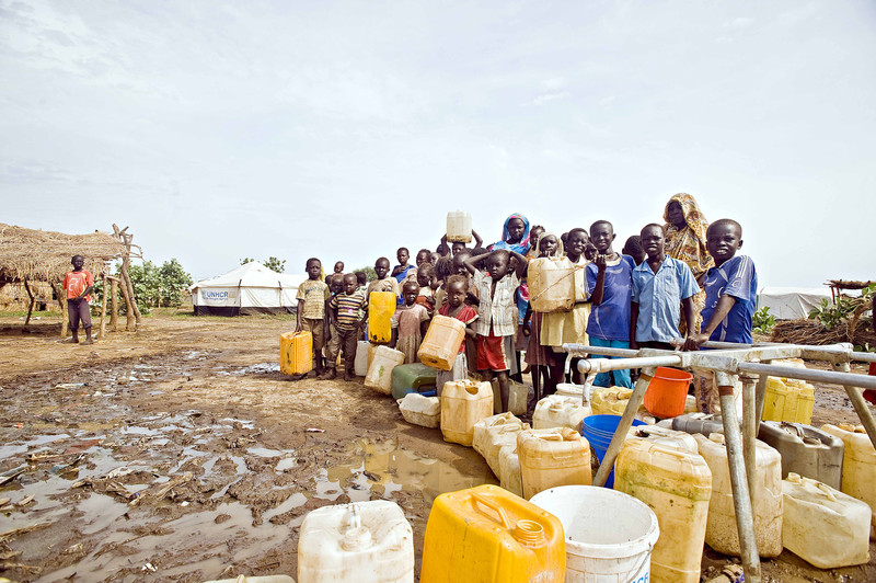Children and women queue at a water point, in Jamam refugee camp, Republic of South Sudan.