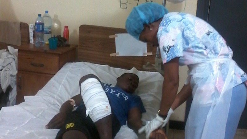 A nursing student, Marconi H. Collins, caring for a patient at the Redemption Hospital on the Bushrod Island.