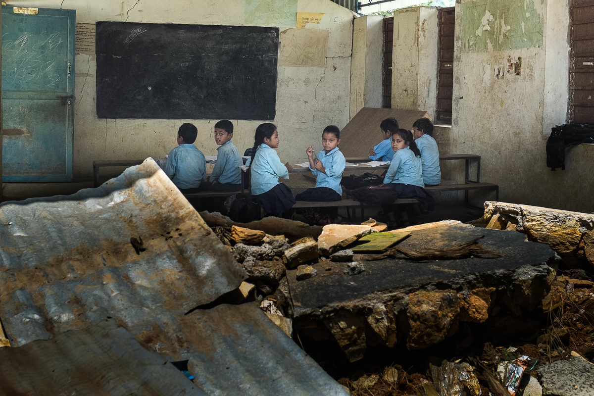 Students attend classes inside school buildings damaged by the earthquake on 10 August 2015 in Sipa Pokhari, Nepal. This school in Sipa Pokhari VDC was badly damaged during the earthquake, but with only one tent provided by NGOs, the rest of the students