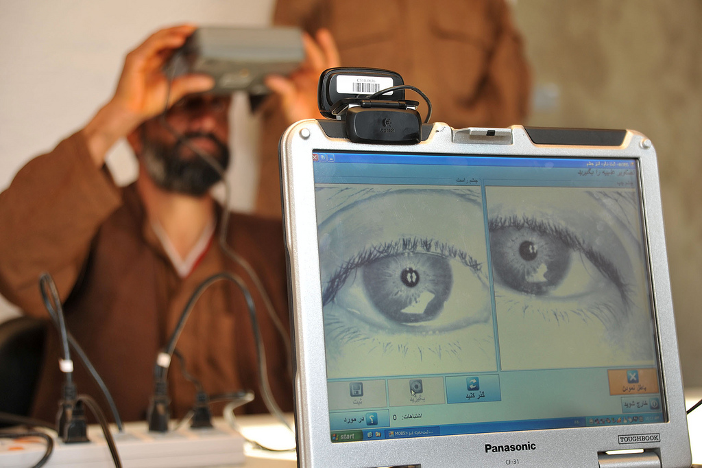 A member of the Afghan Local Police (ALP) looks into a biometric eye scanner during in-processing into the ALP by members of the Afghan Ministry of Interior in Gizab district, Uruzgan province, Afghanistan