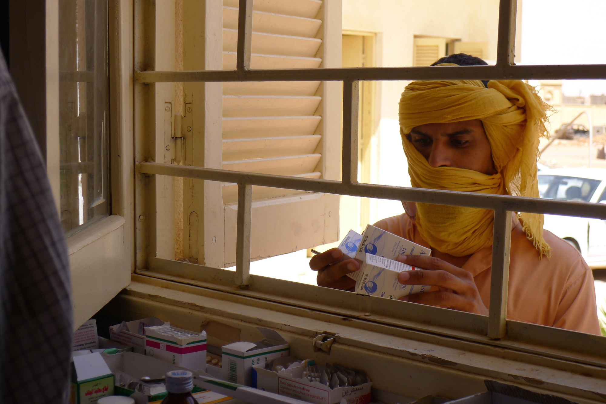 A Libyan man receives medication from the only pharmacy in Ubari, a town in southern Libya