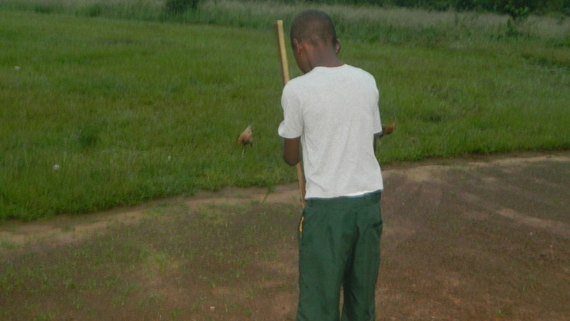 14-year-old Tony, whose parents died from Ebola last year, sweeps the courtyard outside the orphanage he now lives in. More than 16,000 children in Guinea, Liberia and Sierra Leone lost one or both their parents to the deadly virus.