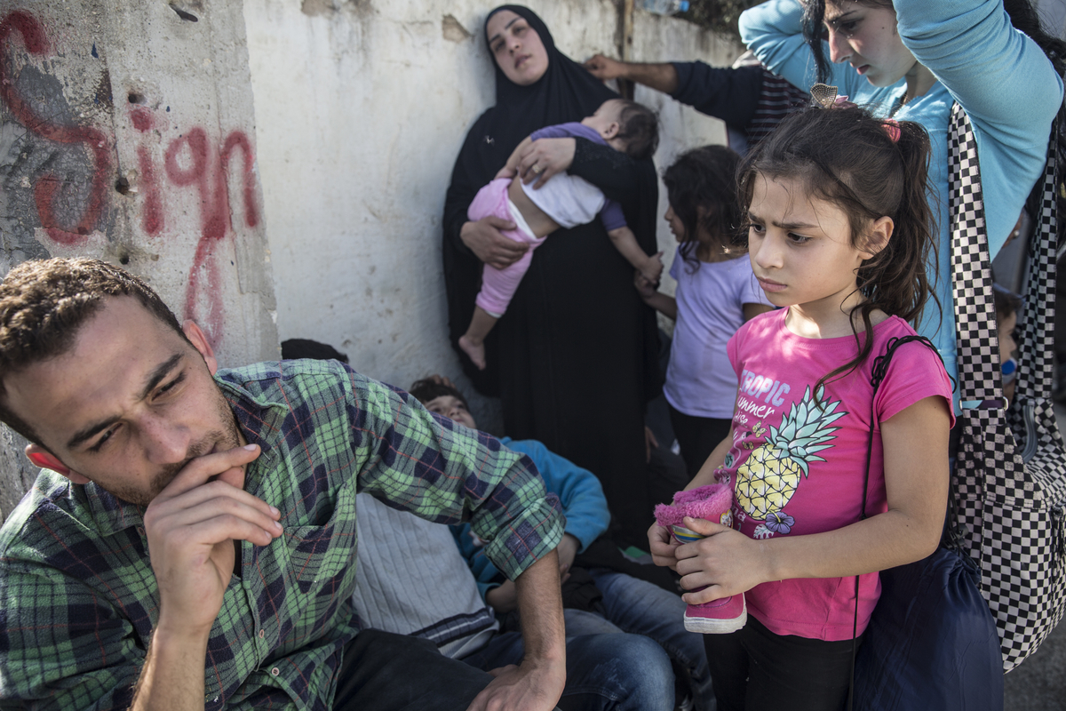 Alla Abdo, left, with his cousin Jihan and her four children, outside Moria reception centre on the Greek island of Lesvos. Abdo said they were Syrians but had lost their documents and been told they could not register at Kara Tepe, a reception centre for