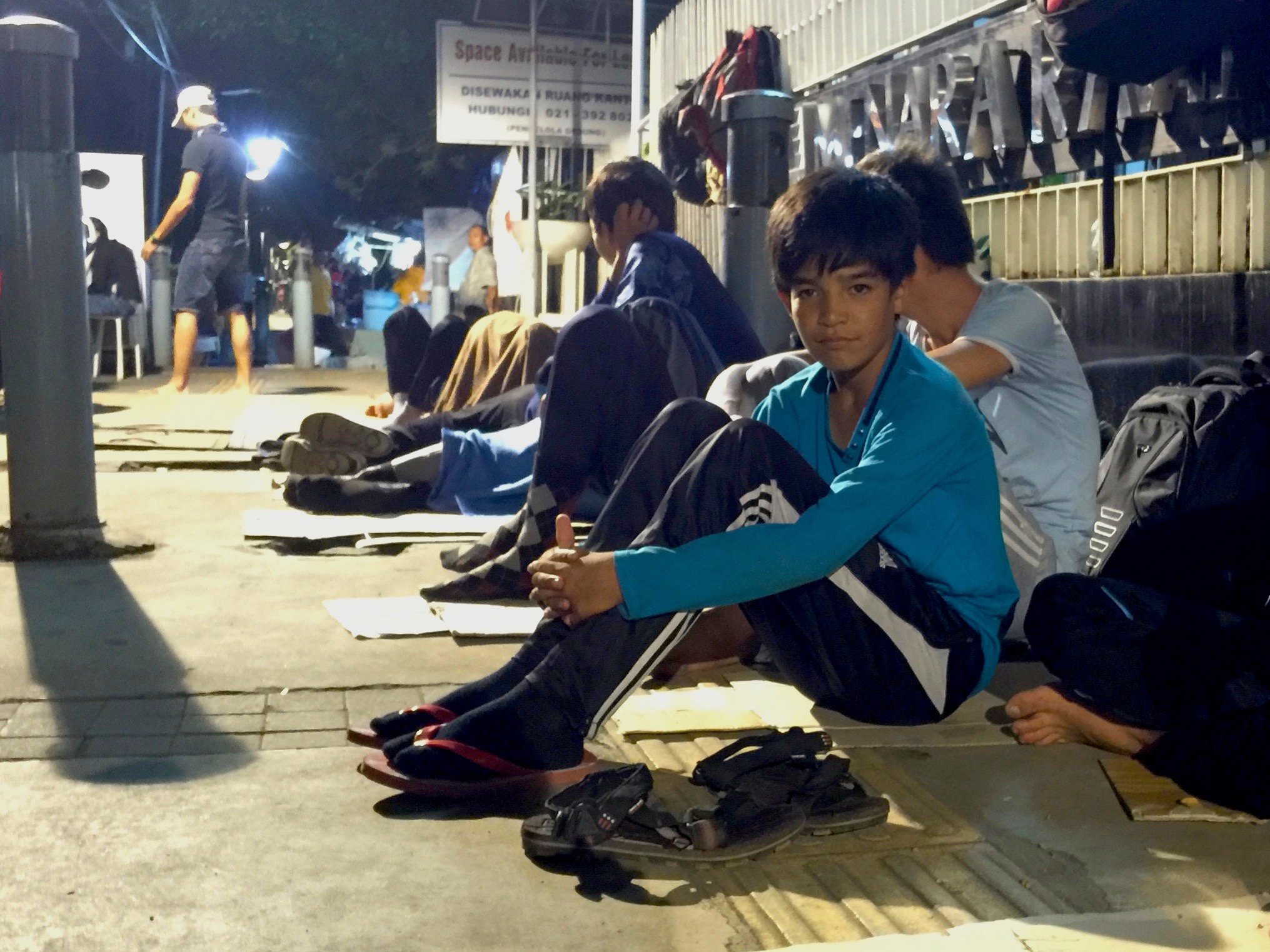 Ethnic Hazara refugees from Afghanistan and Pakistan camp outside the UNHCR office in Jakarta, Indonesia, in December 2015