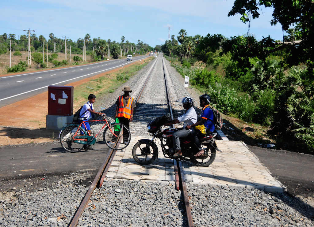 People near the northern Sri Lanka village of Pallai cross a railway line that was under construction in September 2014