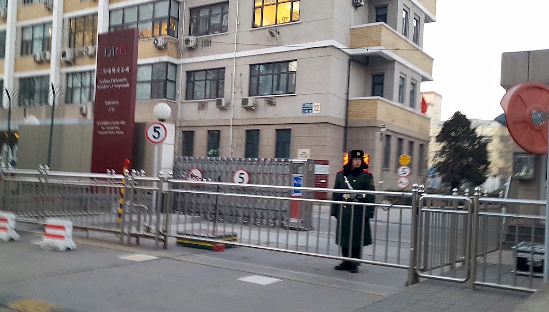 A member of the Chinese People's Armed Police Force stands guard outside the gates of the Sanlitun Diplomatic Residence Compound in Beijing, China, where some foreign NGOs are based