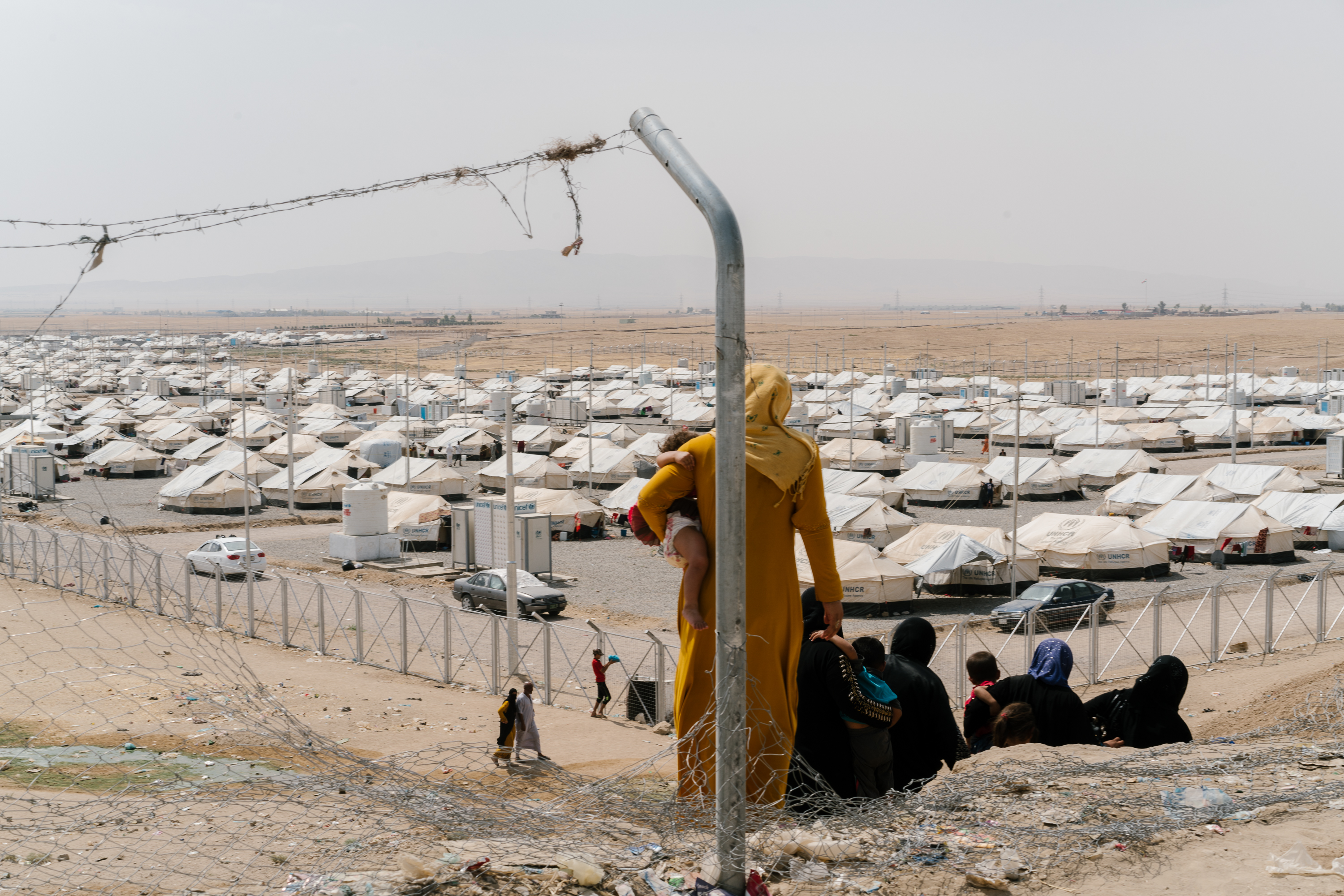 People standing in front of a camp