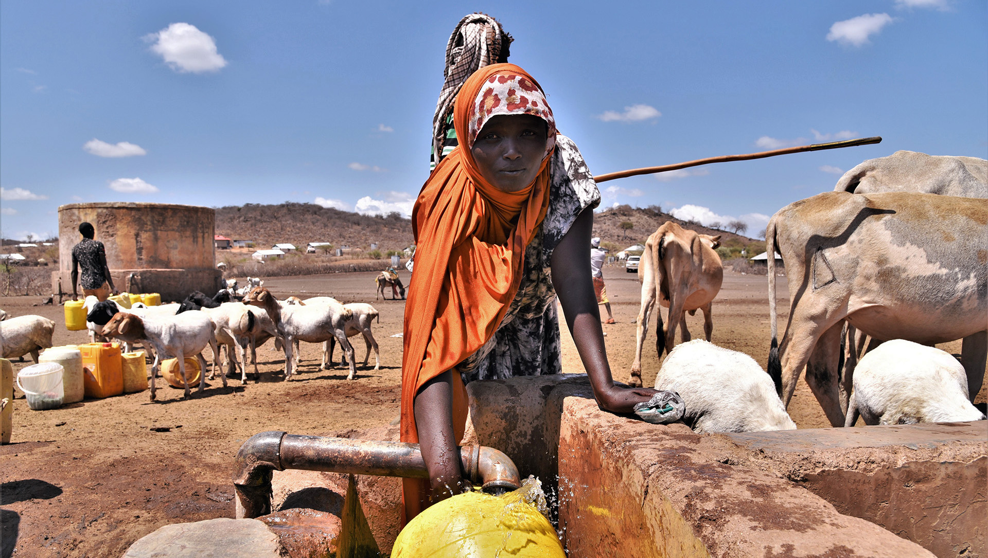 A woman fills a jerry can at a watering point in Kulu Mawe.