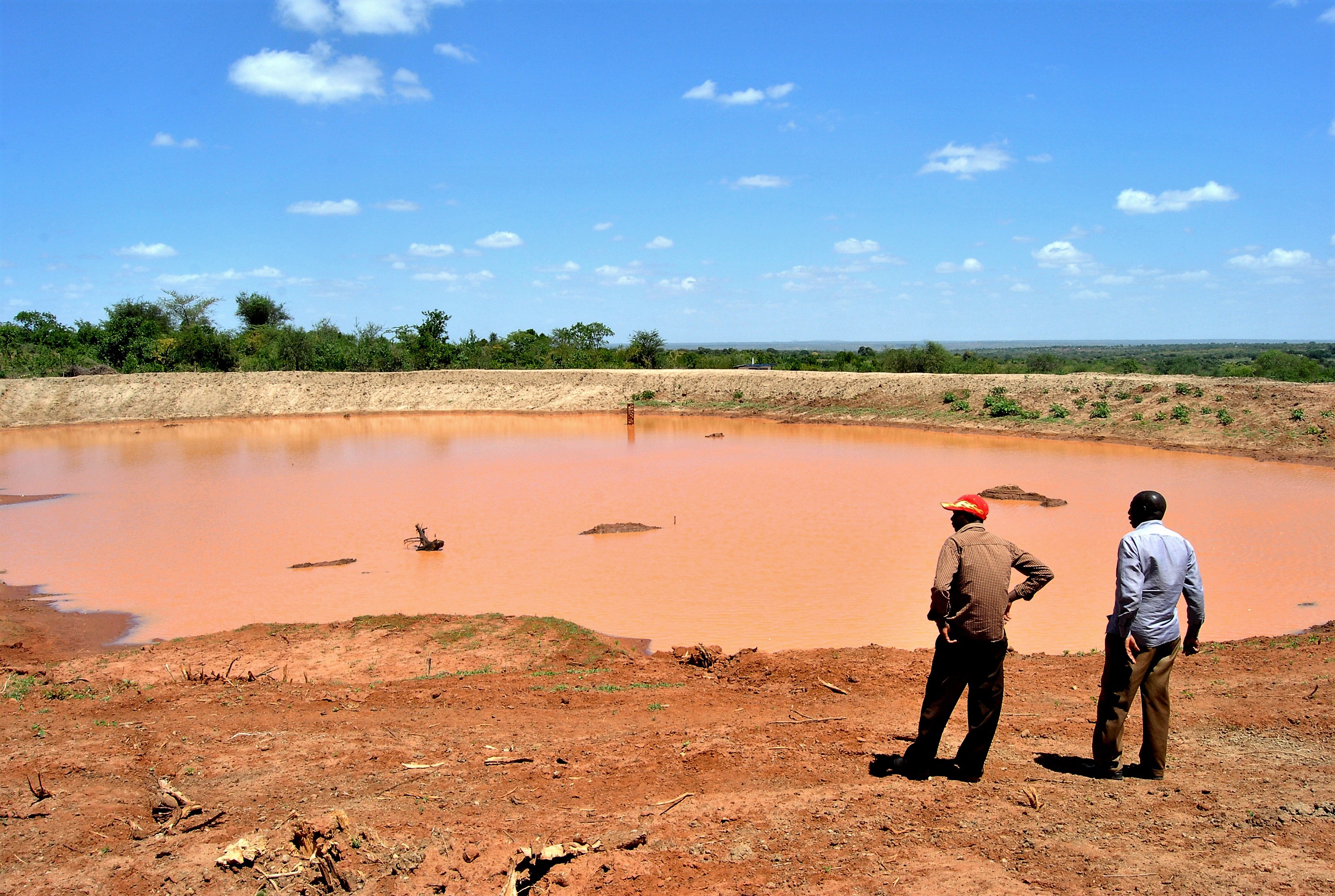 James Mbatha (Left), the secretary of the Nguu Masumba Ward Climate Change Committee with a fellow villager inspecting the Kwa Mutuku dam in Makueni.