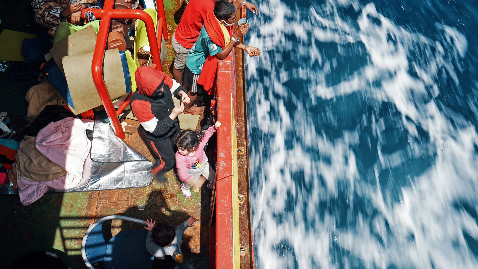Rescued asylum seekers and migrants on board the Sea-Eye 4 as the ship waits for a port of safety.