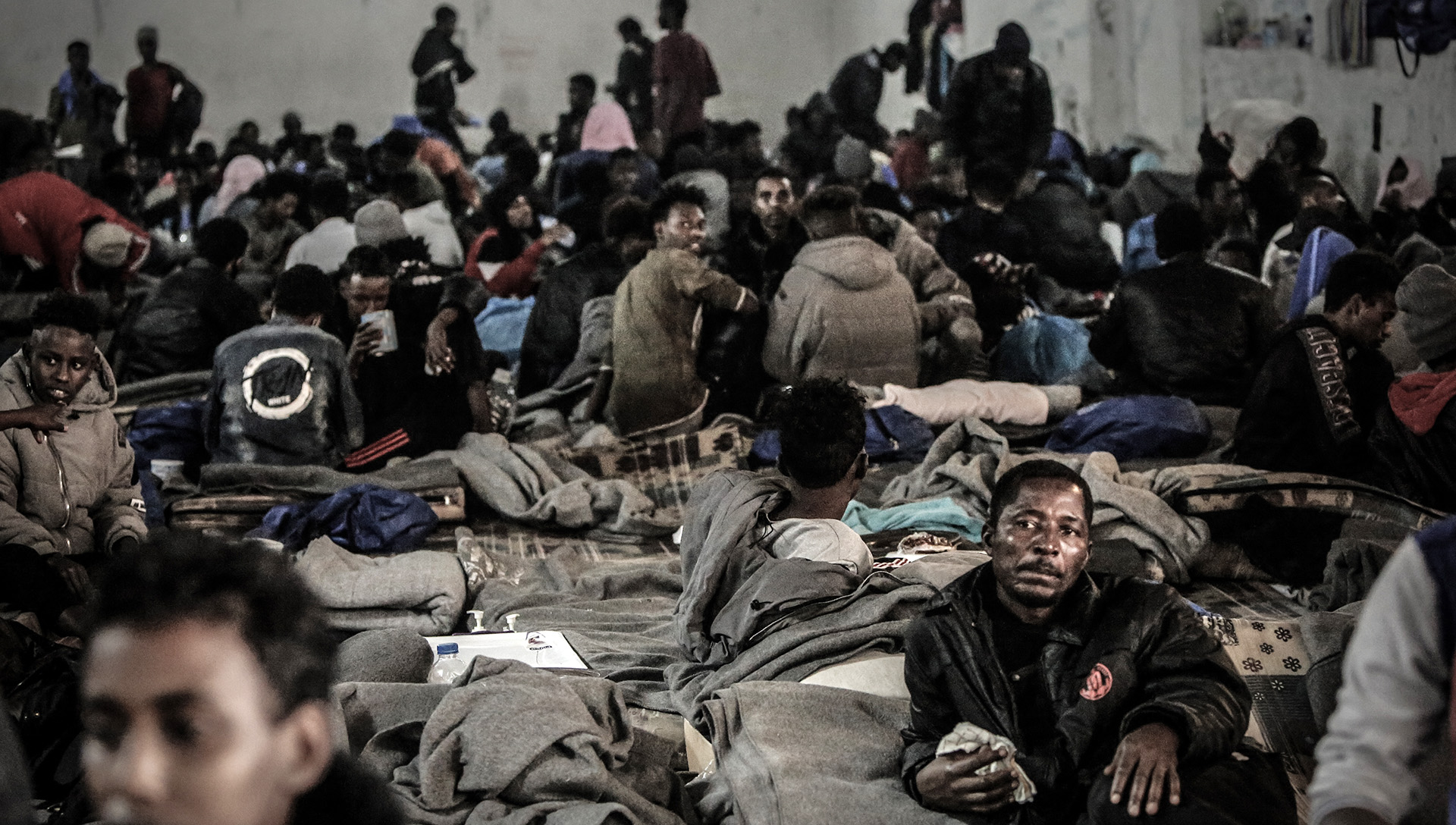 Migrants arbitrarily detained at Tarik al-Sika detention centre in Tripoli – one of around 20 facilities where detainees in Libya are trapped in a cycle of extortion, torture, and trafficking – on 16 December 2020.
