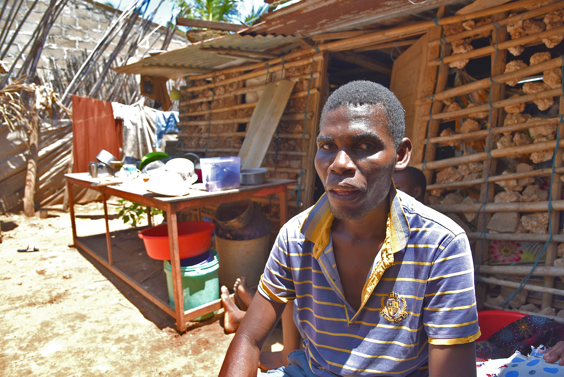 Abudo Akimo lives with three displaced families in Pemba but only one is registered for food aid. Everyone shares what they have. Akimo collects crabs and shellfish as his contribution.