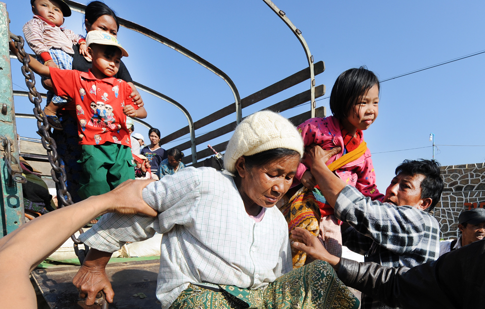 A family displaced by fighting between the Ta'ang National Liberation Army and the Restoration Council of Shan State arrives at a monastery in the Myanmar town of Kyaukme