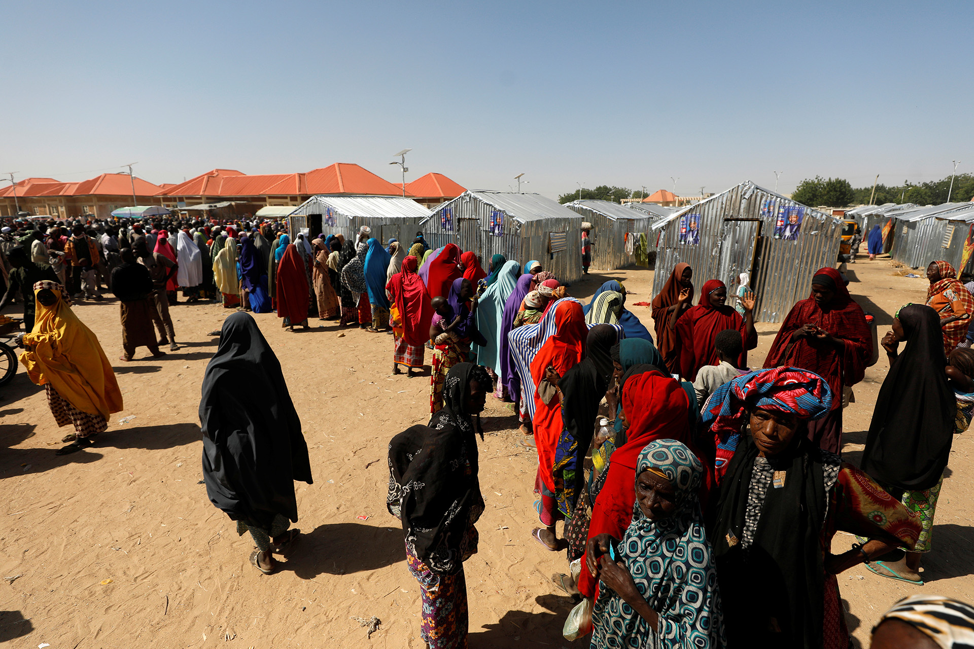 Women queue for relief at the Teachers' Village IDP camp in Maiduguri, 2019. The conflict has displaced more than two million people.