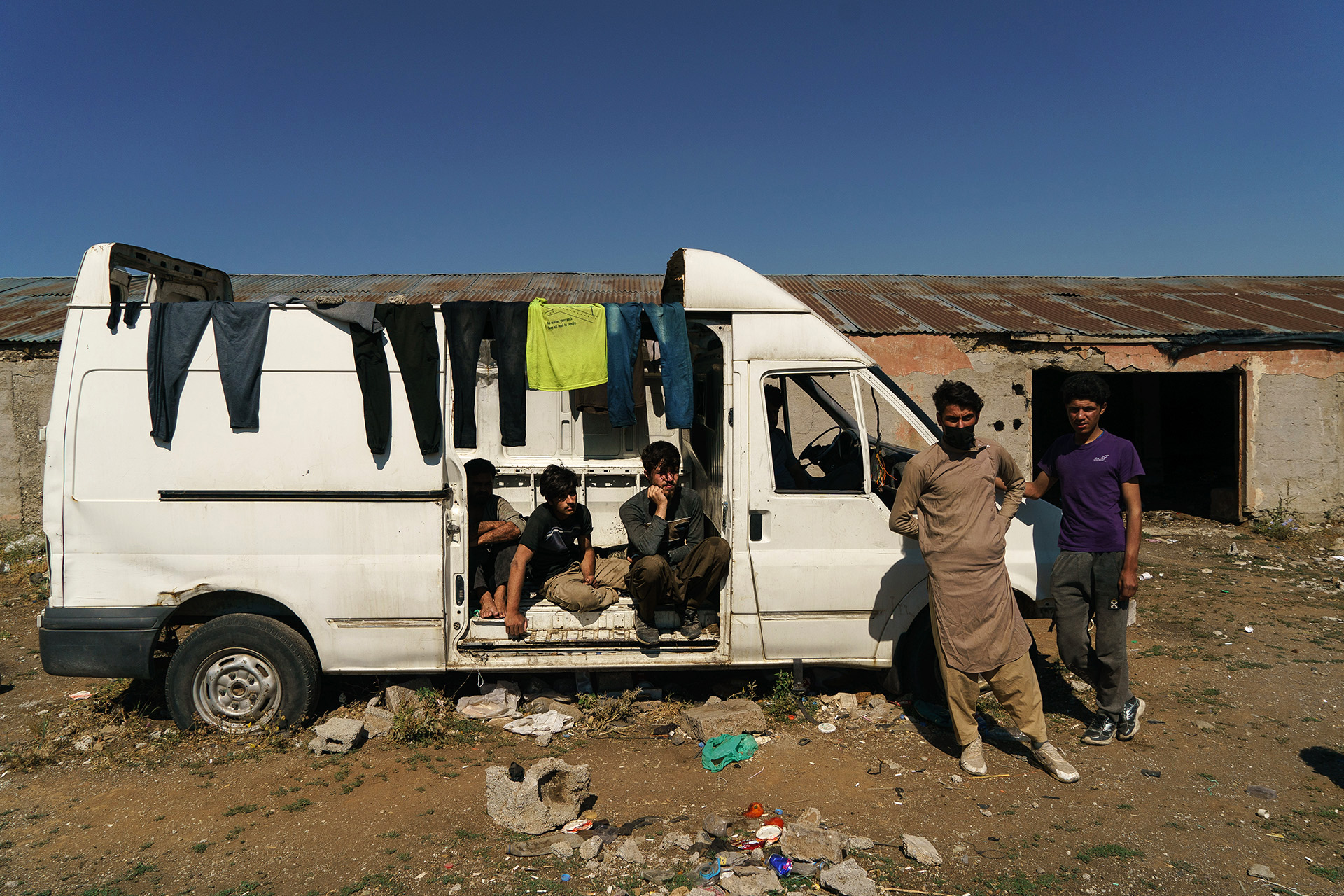 Omer and his friends await transportation at an abandoned farm, near the city of Tatvan. The group said they were beaten by Iranian border guards, and their clothes were taken from them.