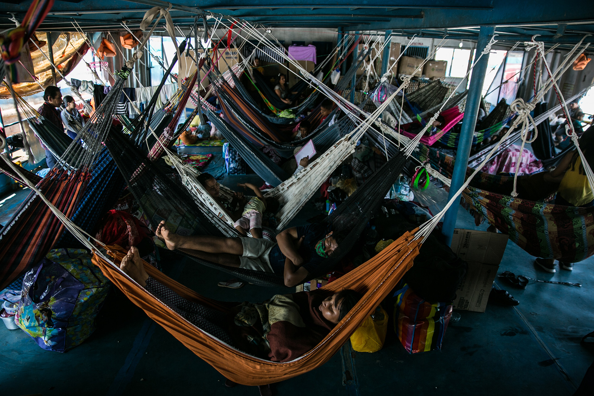 Image of residents from Amazon River communities waiting in tight quarters in Pucallpa