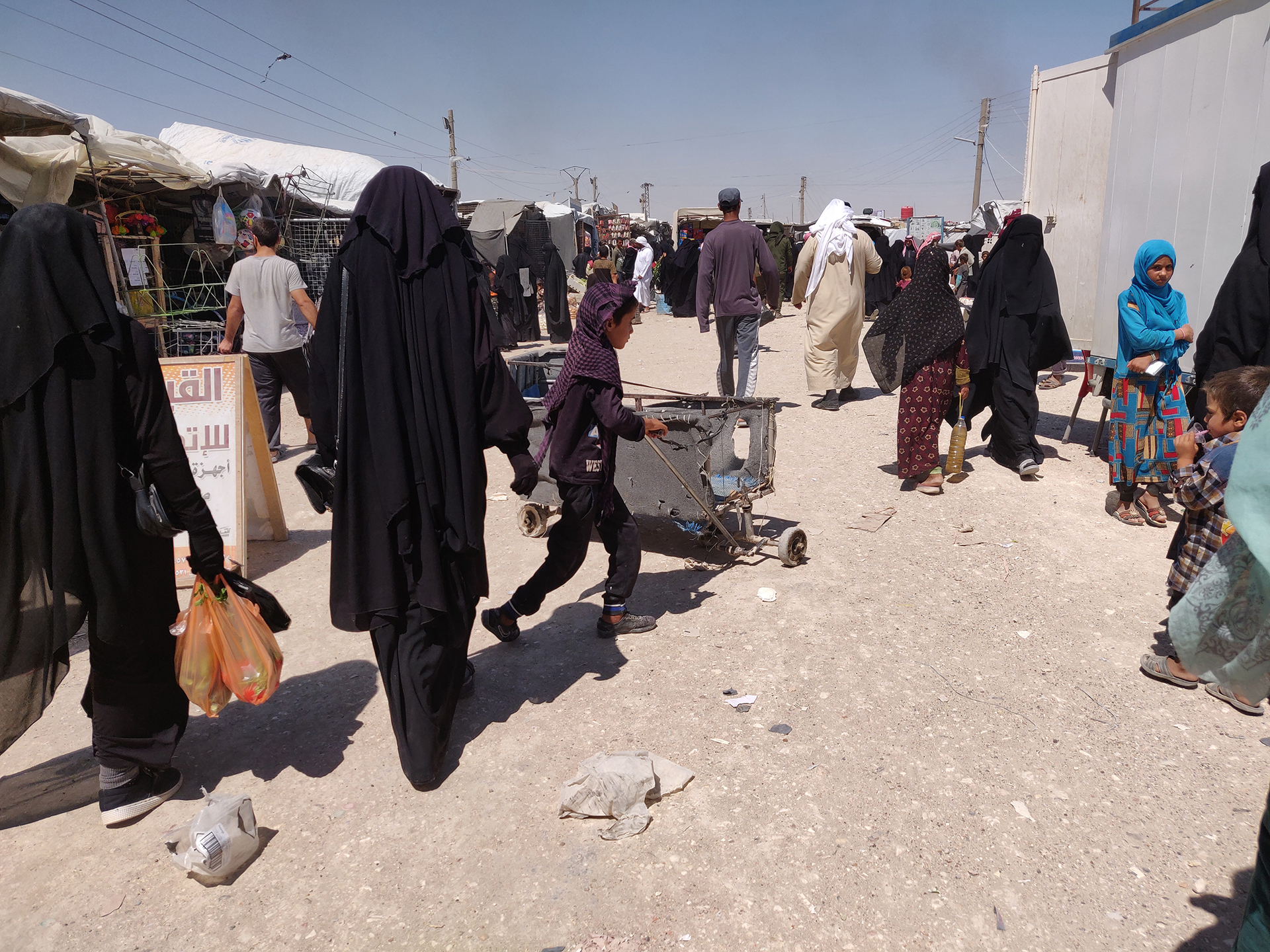 Photo of people inside the market in the al-Hol camp in Syria