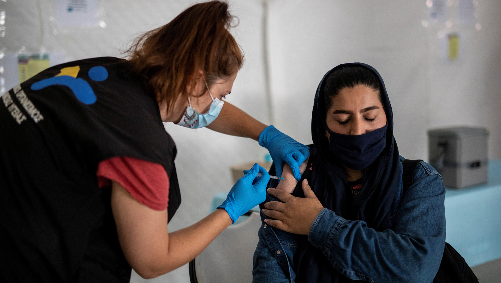 A migrant receives a shot of the Johnson & Johnson vaccine against COVID-19 in the Mavrovouni camp for refugees and migrants on the island of Lesvos, Greece, 3 June, 2021.