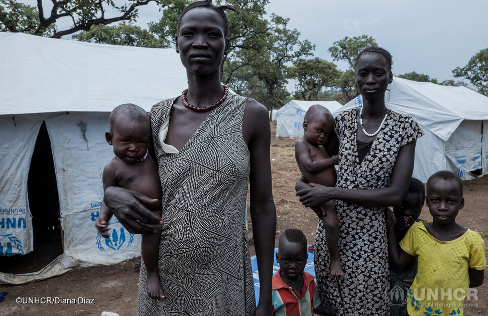 Newly arrived refugee women hold their young children in Nguenyyiel Camp